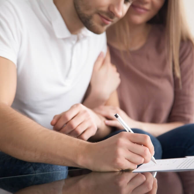 Image showing a close up of a couple signing paperwork