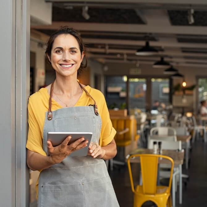 Image showing a woman with a table at a restaurant entrance