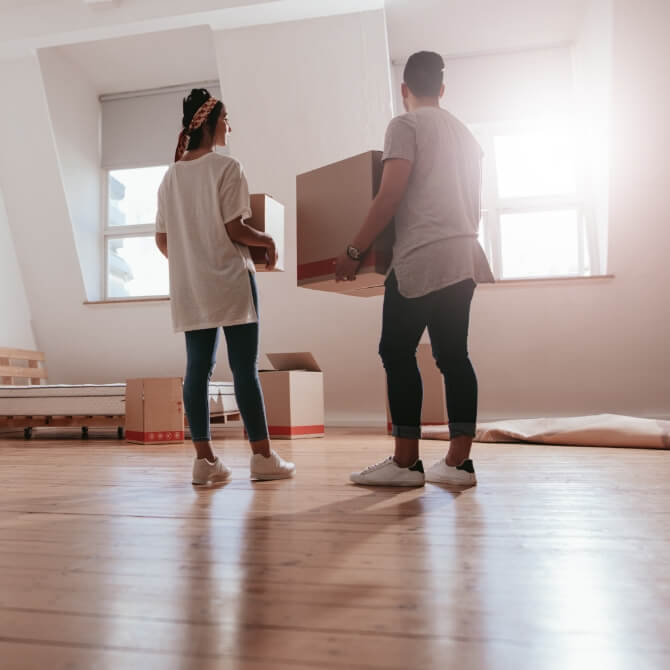 Image showing a couple in an empty room with boxes