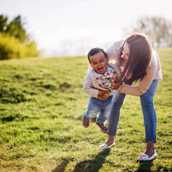 Image showing a mother playing with her son in a field