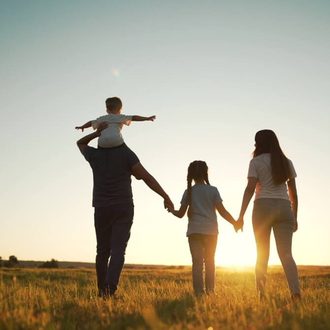 Image showing a family in a field at sunset