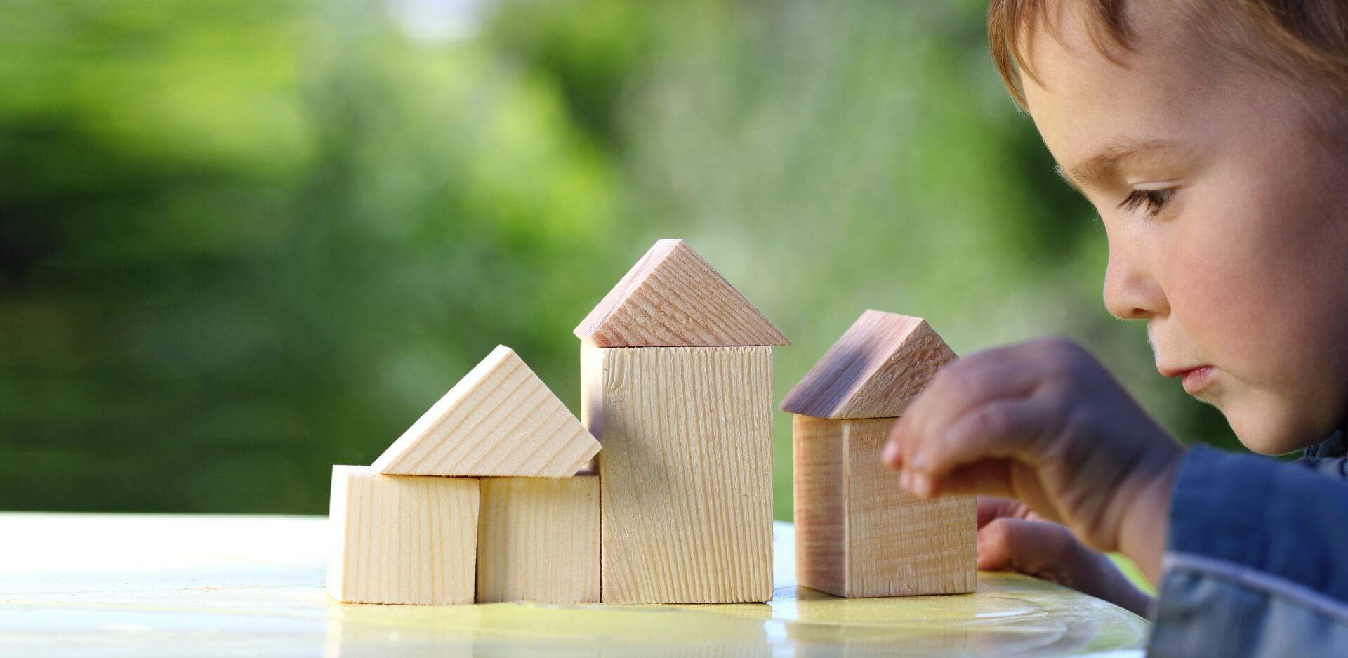 Image showing a little boy making houses out of bulding blocks