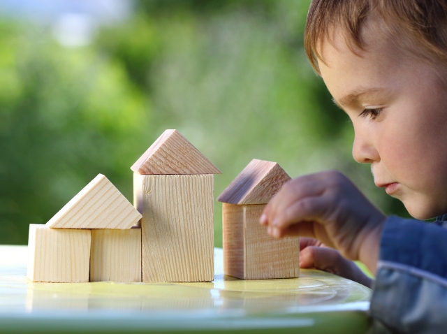 Image showing a little boy making houses out of bulding blocks